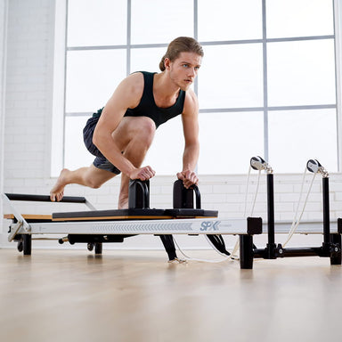 The Merrithew At Home SPX Reformer is a reformer machine that combines smooth resistance and easy adjustments for powerful, low-impact workouts.