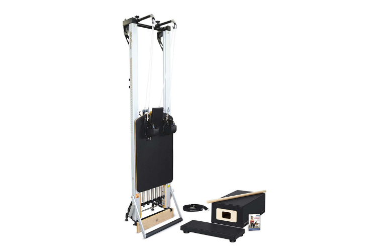 A professional Merrithew reformer with a vertical frame and black vinyl upholstery for elite Pilates reformer equipment sets.