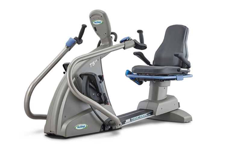 Nustep t5xr recumbent cross trainer with a reclining seat and adjustable handles for safe clinical rehabilitation sessions.