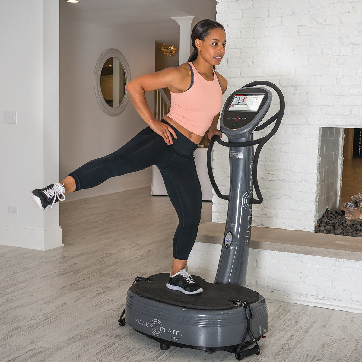 Power plate machine My7 featuring an integrated LCD touchscreen and retractable resistance training handles.