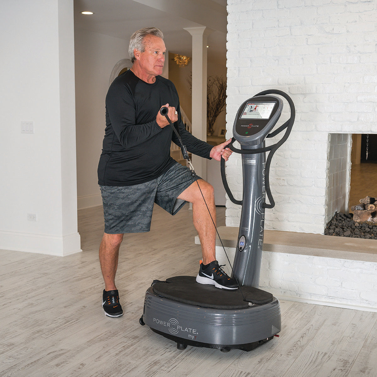 Power plate machine My7 featuring an integrated LCD touchscreen and retractable resistance training handles.