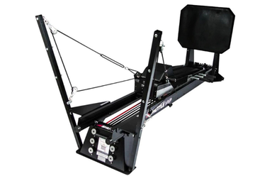 The Shuttle MVP shuttle exercise machine featuring a PNF Total Body Tower for integrated arm and leg conditioning.