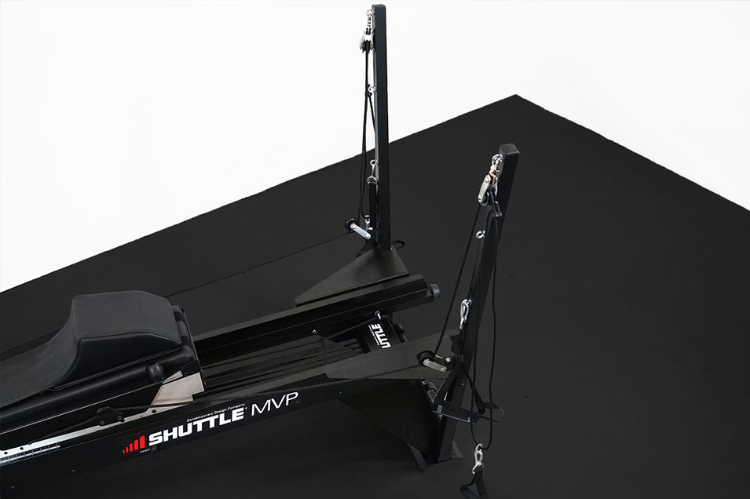 The Shuttle MVP shuttle exercise machine featuring a PNF Total Body Tower for integrated arm and leg conditioning.