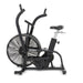 Durable commercial stationary bike with a contoured adjustable seat, integrated windscreen, and transport wheels.