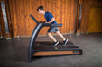 SportsArt Status Verde N685 Eco-Natural heavy duty commercial treadmill currently in use for gym workouts.