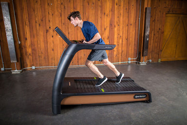 SportsArt Status Verde N685 Eco-Natural heavy duty commercial treadmill currently in use for gym workouts.