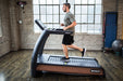 SportsArt Status Verde N685 Eco-Natural heavy duty commercial treadmill currently in use for gym workouts.